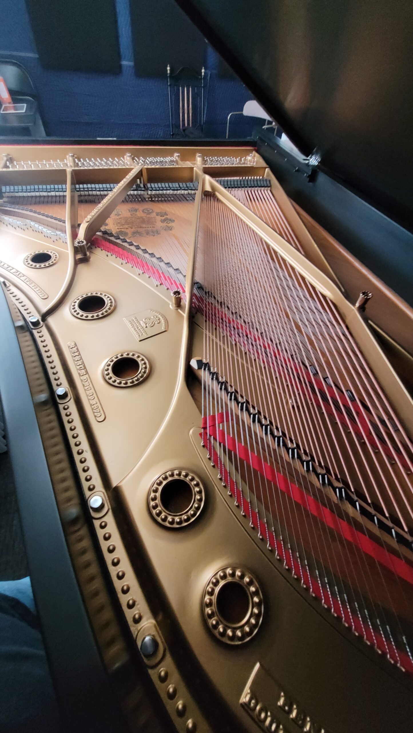 The gilded plate and strings of the restored Steinway